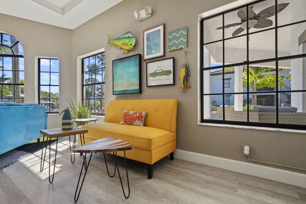 Sitting area in clubhouse surrounded by large windows