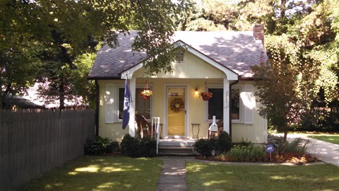 A house with a flag on the front porch.