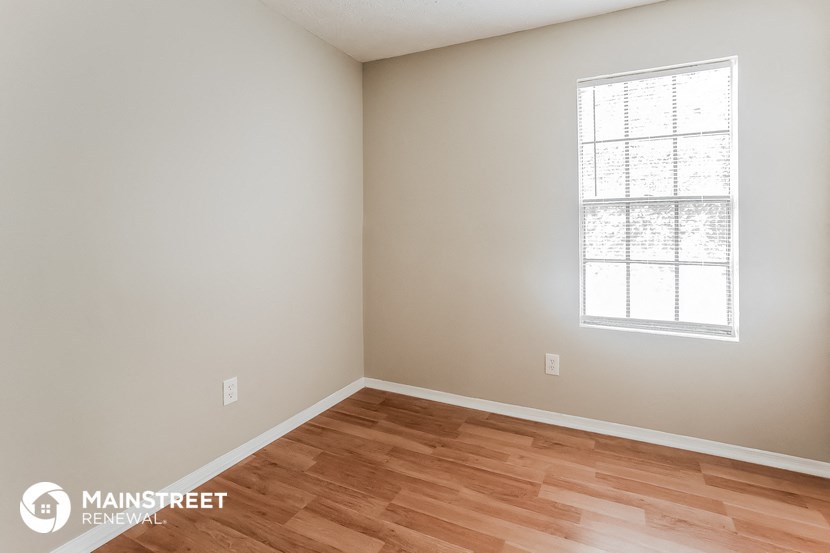 the interior of a home with wood floors and a window