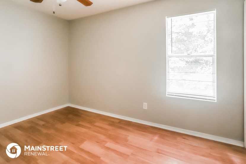 the interior of a room with wood floors and a window