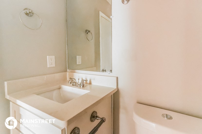 a bathroom with a sink and a mirror and a toilet