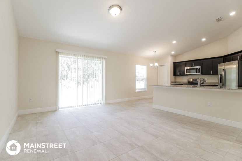 the kitchen and living room are spacious and open to the backyard