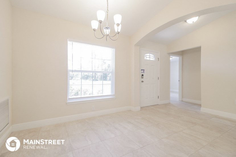 the living room and dining room with the door to the kitchen