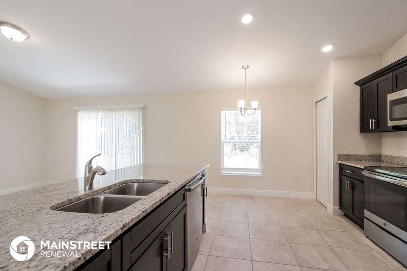 a kitchen with granite counter tops and black appliances