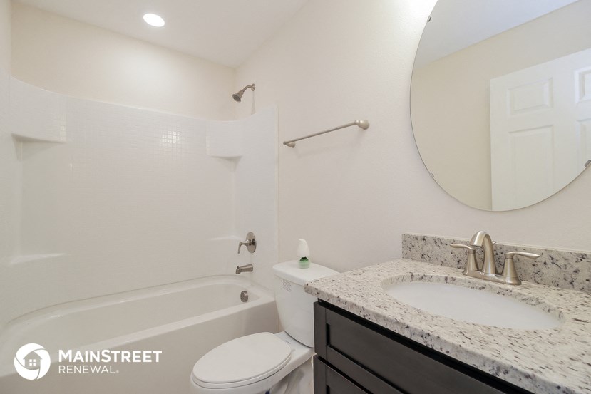 a bathroom with a sink and a toilet and a bath tub