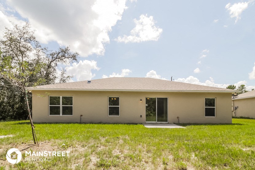 the view of the front of a home with a yard and grass