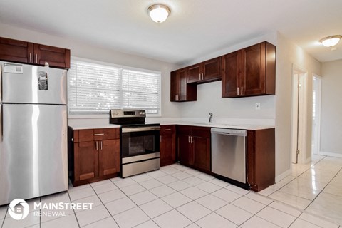 a kitchen with wooden cabinets and stainless steel appliances