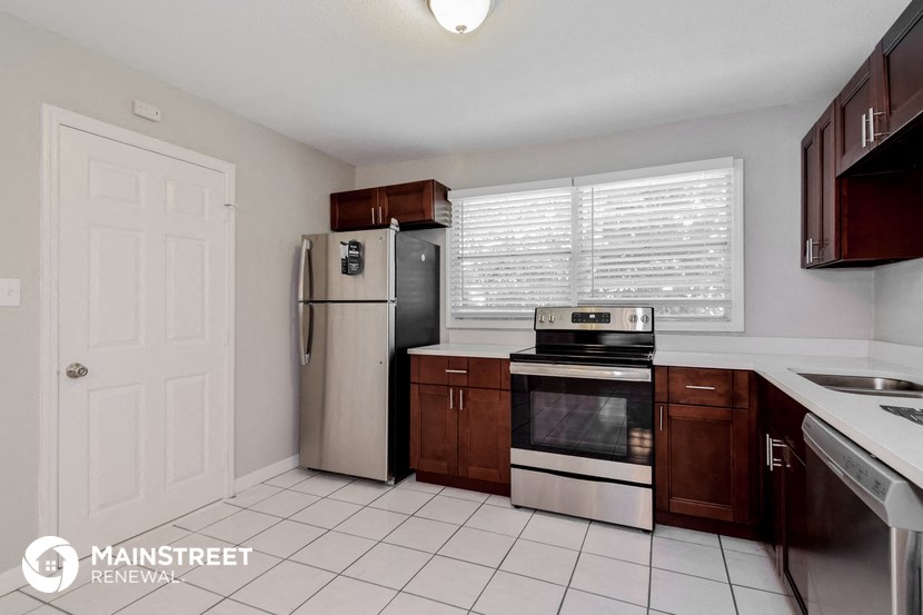 a kitchen with a stove refrigerator and a sink