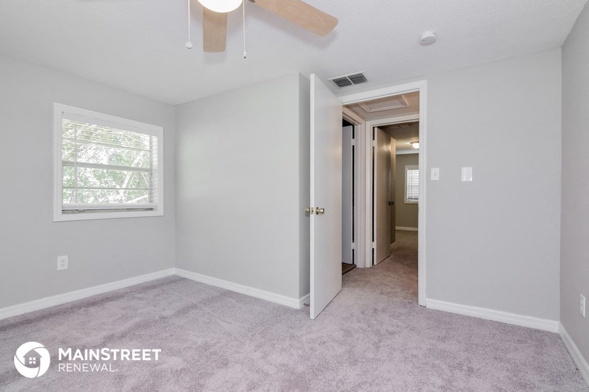 the master bedroom is spacious and has a ceiling fan