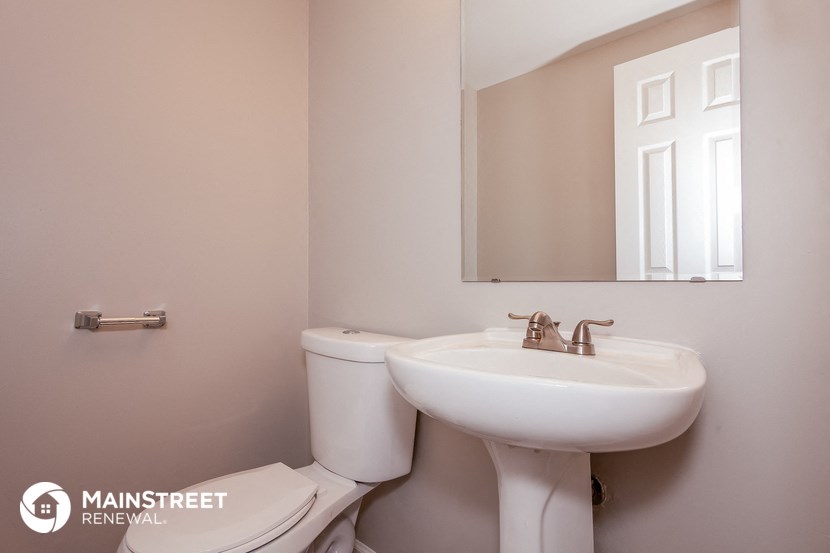 a bathroom with a sink and a mirror and a toilet