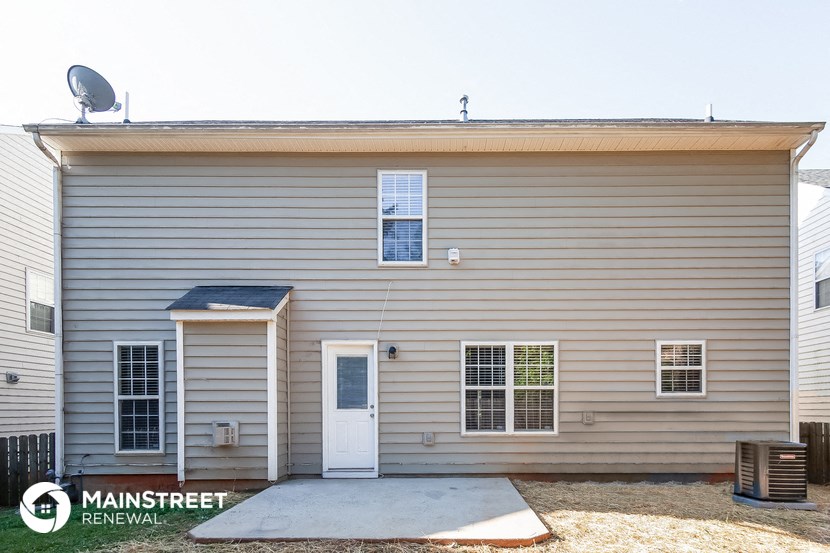 a white house with a white door and a satellite dish on the roof