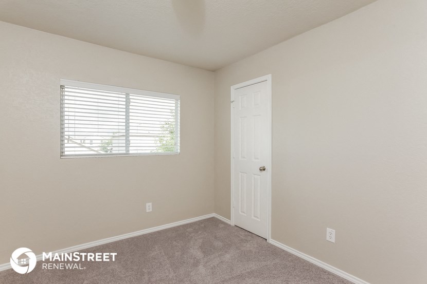 the upstairs bedroom with a door and window