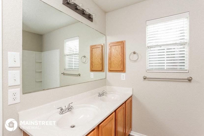 a bathroom with two sinks and a large mirror