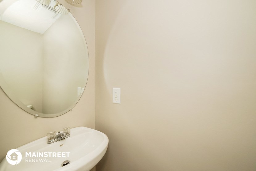 a white bathroom with a mirror and a sink