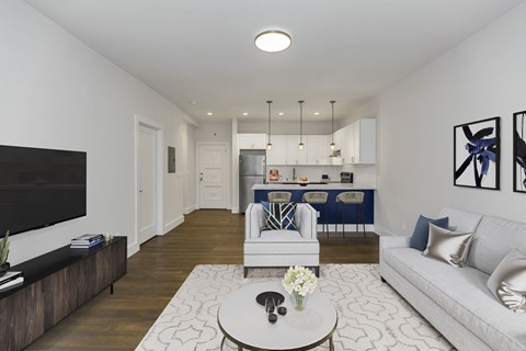A modern living room with a white couch and a coffee table.