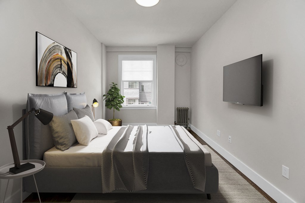 A modern bedroom with a large bed and a flat screen TV mounted on the wall.