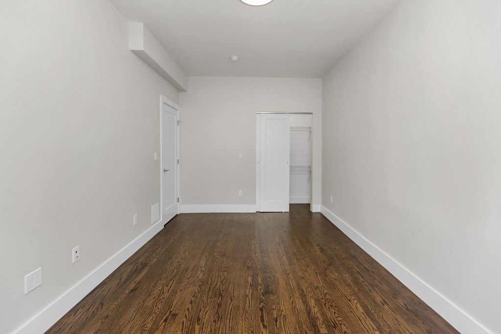 A room with wooden floors and white walls.