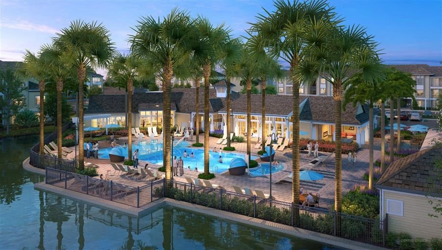 an aerial view of a resort with a pool and palm trees