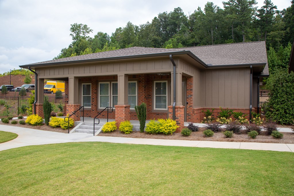 a home with a lawn and a sidewalk in front of it