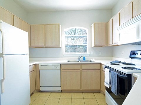 a kitchen with white appliances and wooden cabinets