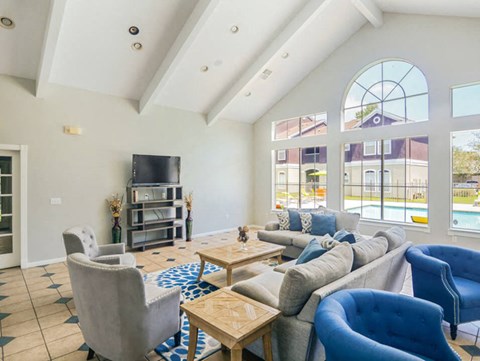 a living room with couches and chairs and a television