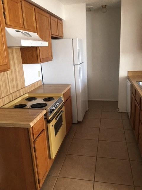 a kitchen with a stove and a refrigerator