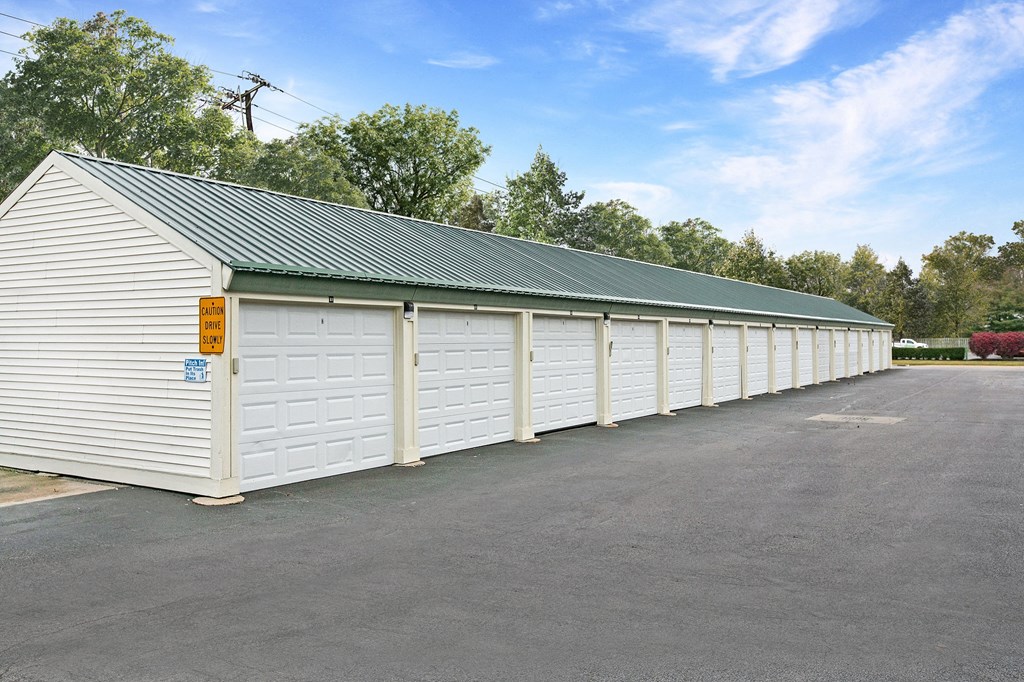 a row of white garages in a parking lot