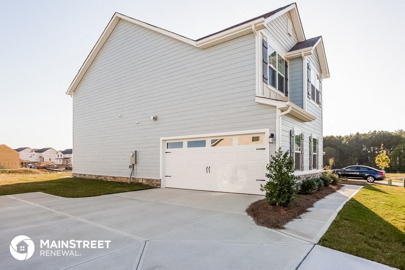 a white house with a white garage door