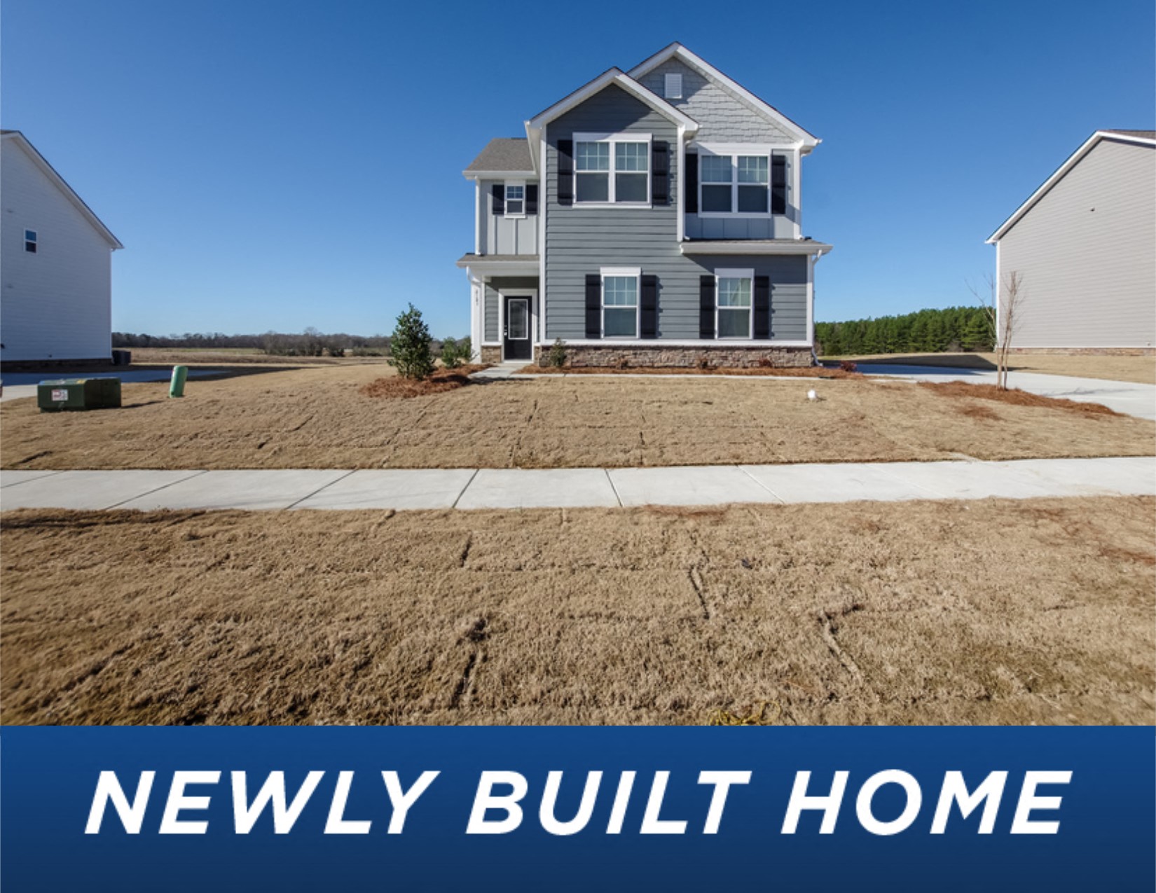 a newly built home with a sidewalk in front of it