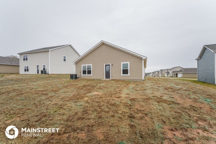 the view of a row of houses on a grassy field
