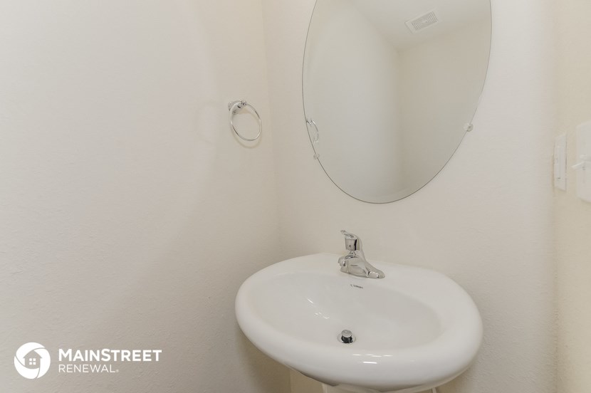 a small bathroom with a sink and a mirror