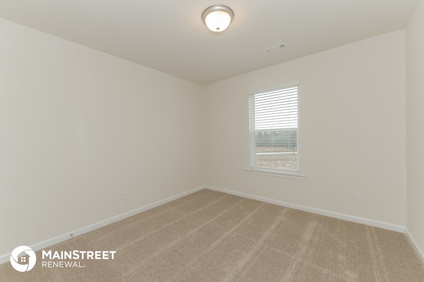 the living room of an empty house with a window