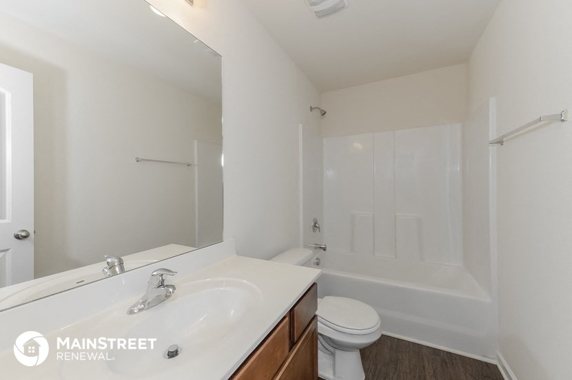 a bathroom with a sink and a toilet and a bath tub