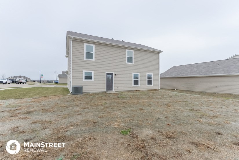 a home with a large yard in front of a house
