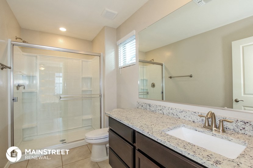 a bathroom with a sink and a shower and a toilet