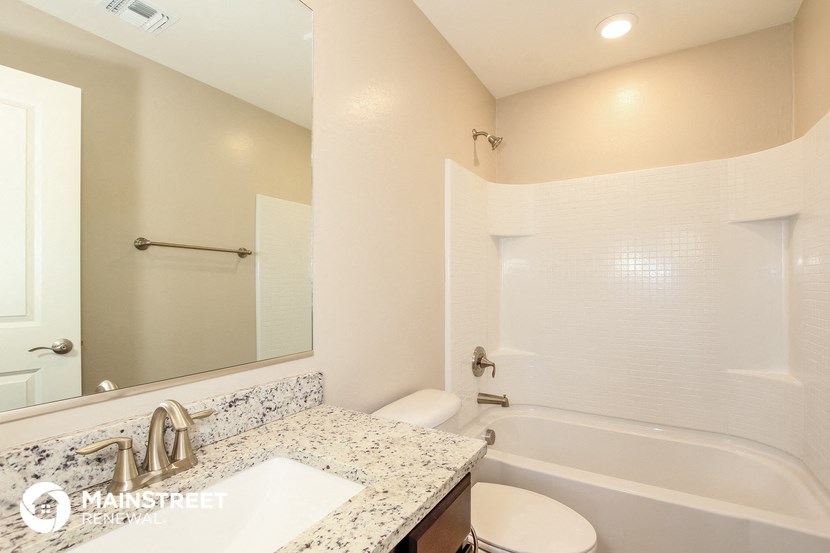 a bathroom with a sink toilet and a bath tub