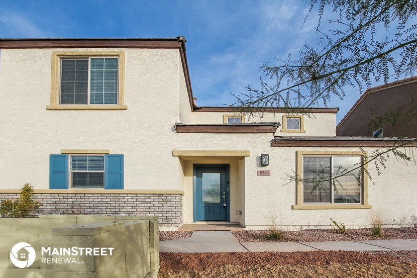 a white house with blue shutters and a blue door