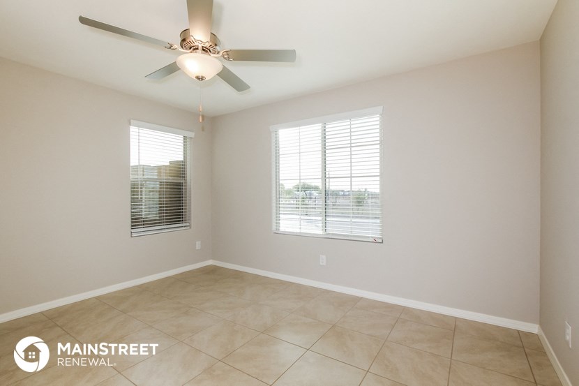 a living room with a ceiling fan and a window