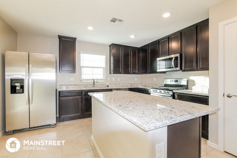 an updated kitchen with granite countertops and stainless steel appliances