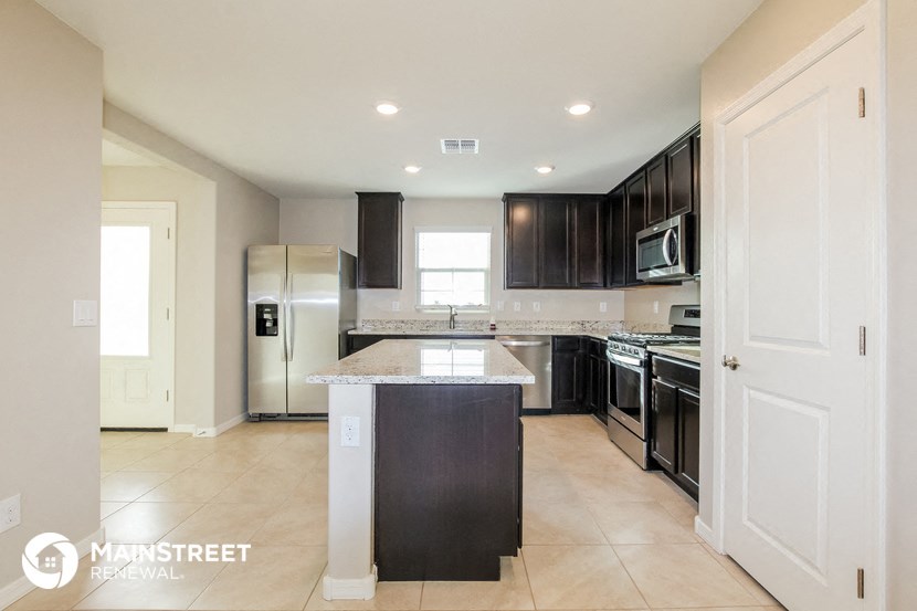 a modern kitchen with black cabinets and stainless steel appliances