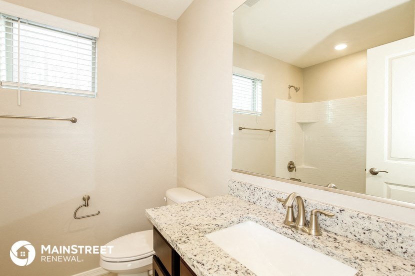 a bathroom with a sink and a toilet and a mirror