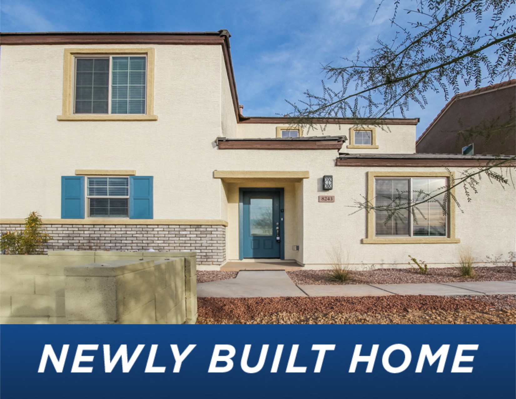 a new build home with blue doors and a white house