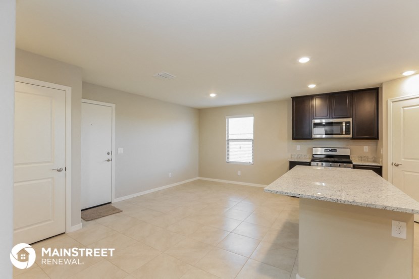 a kitchen with an island and a stove and a microwave