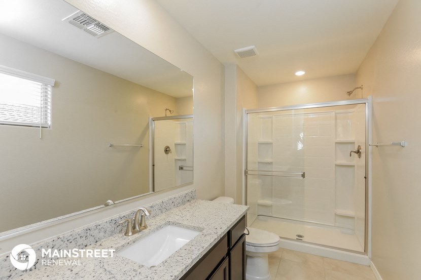 a bathroom with a sink and a shower and a toilet