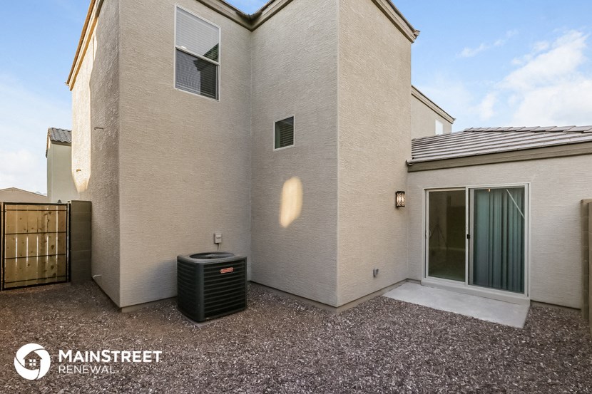 a side view of a house with a trash can in front of it