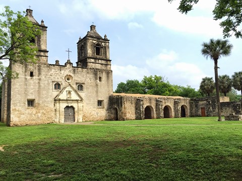 An old stone church with a cross on the front.