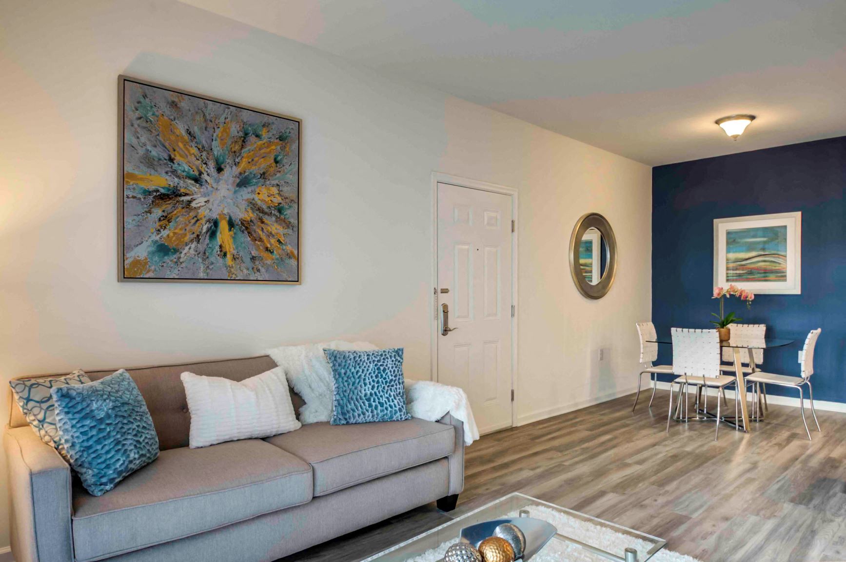 a living room with a couch and a table with chairs