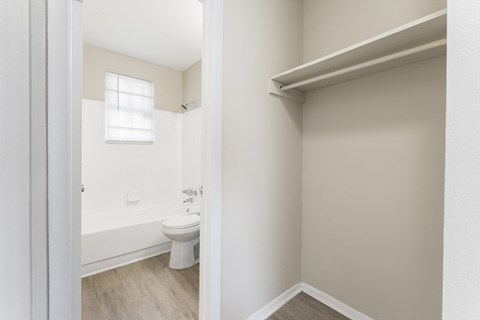 a bathroom with a toilet and a tub and a window