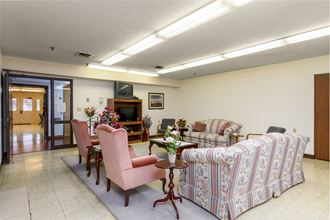 a living room with couches and chairs and a table
