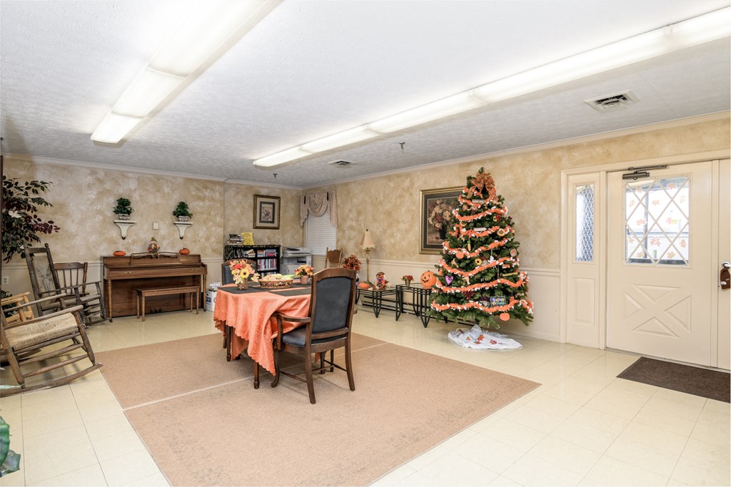 a dining room with a christmas tree and a table and chairs